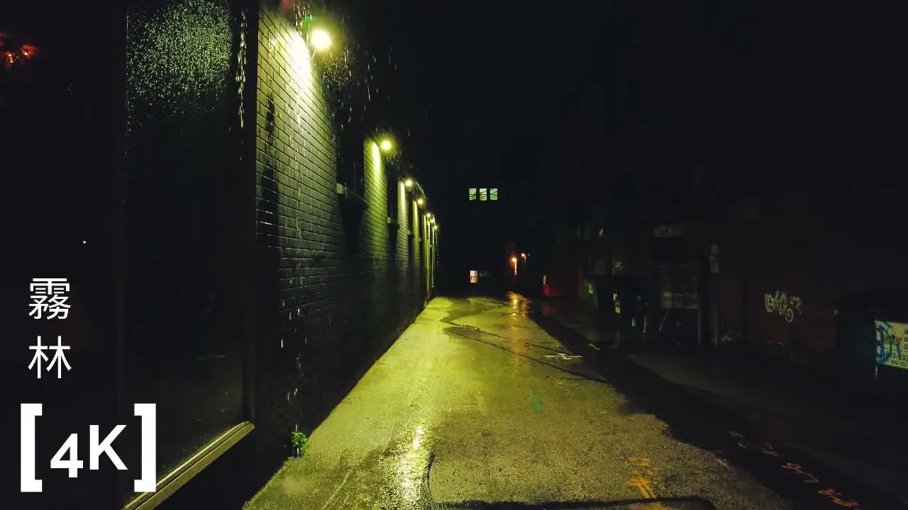 A New England mill town at night in heavy rain: lit wall lamps catching rain streaks over a wet alley